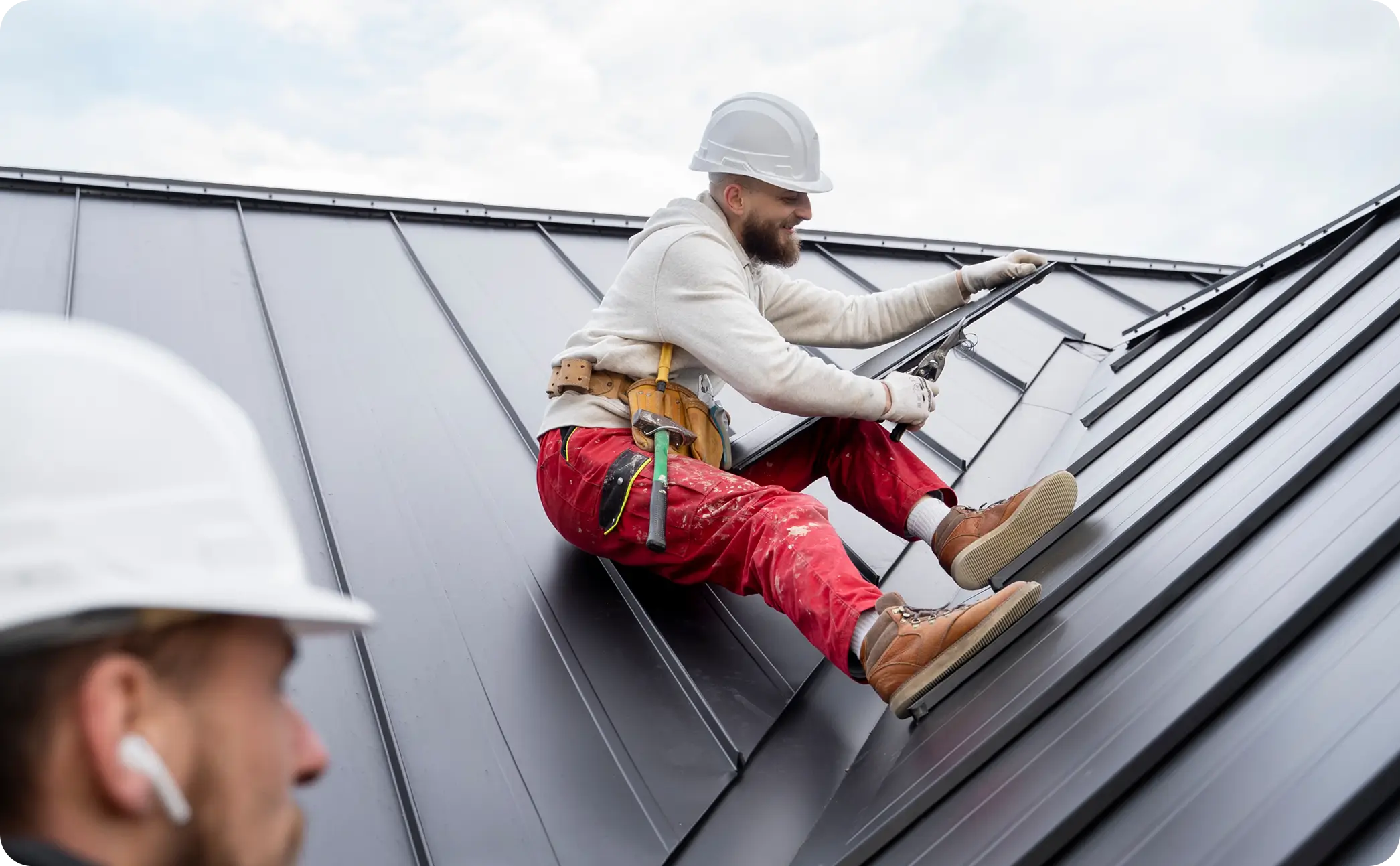 Roofer working on a metal roof
