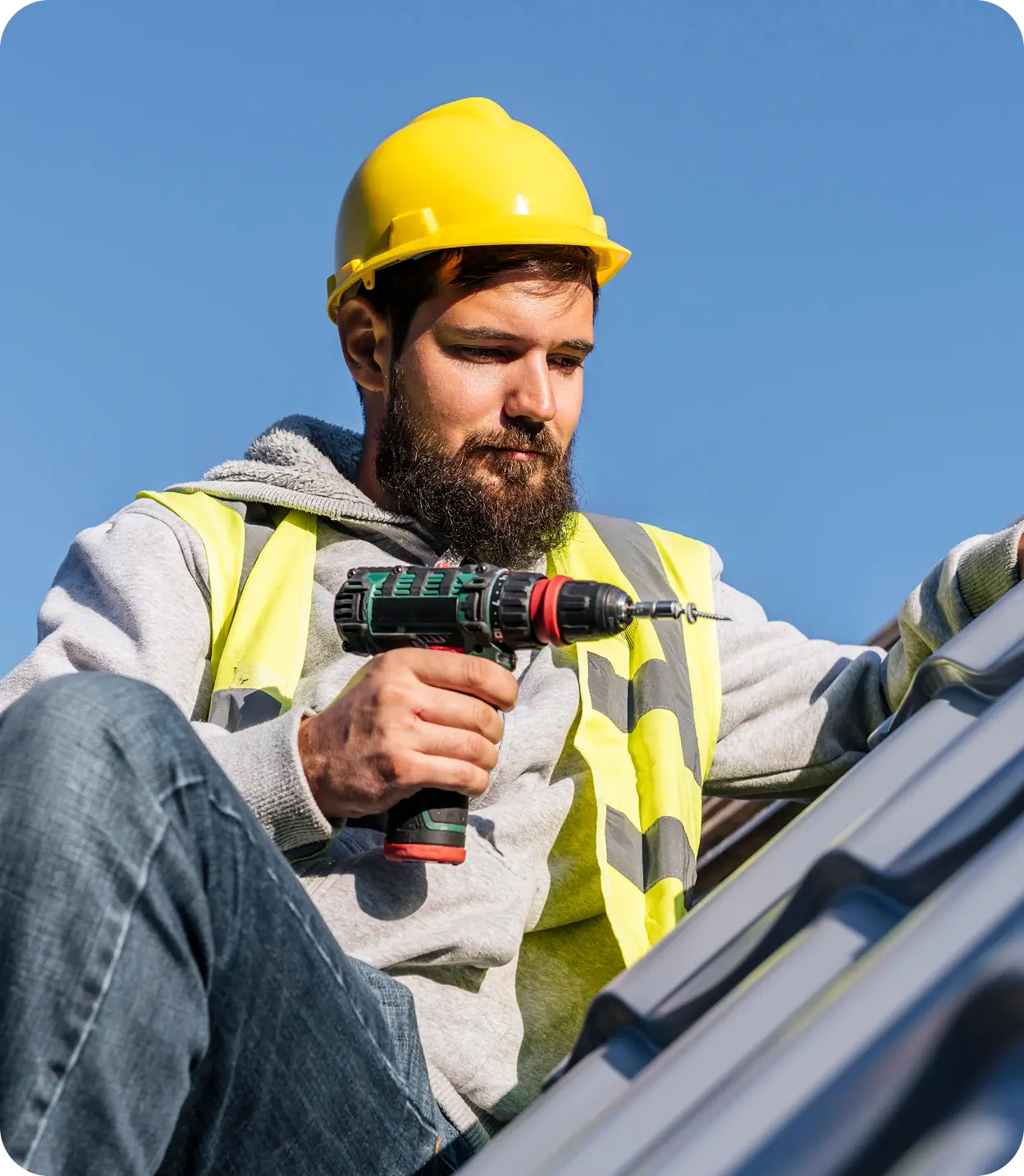 Roofing specialist installing a metal roof panel